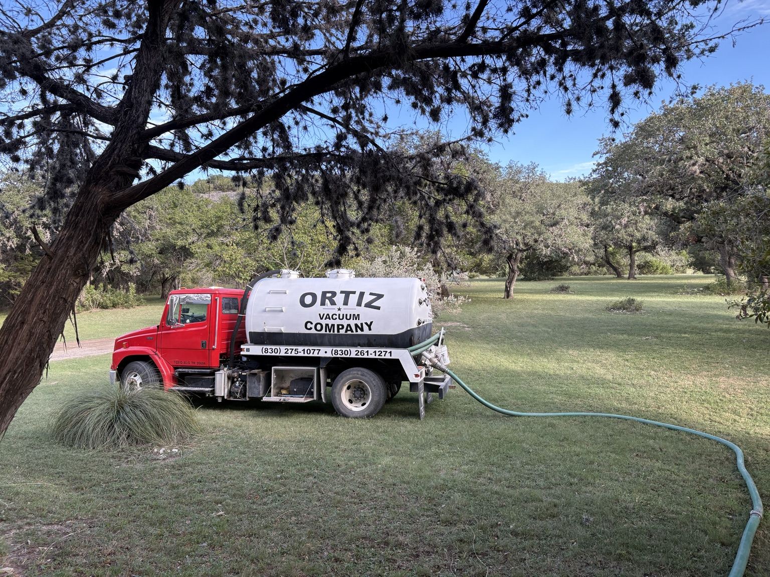 Ortiz Vacuum red septic pumping truck on a service call